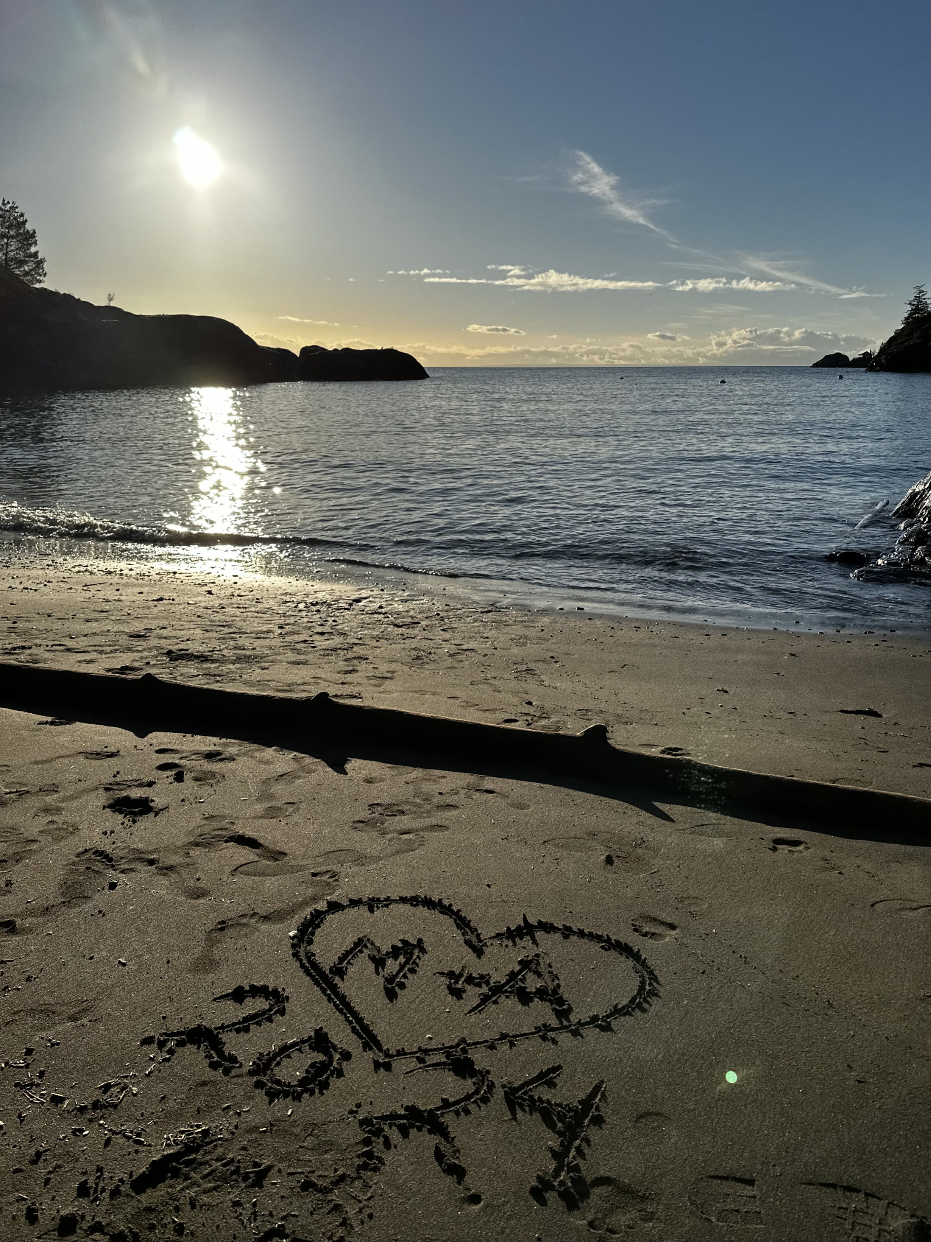 A sandy beach with the setting sun.